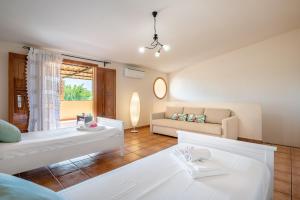 a living room with two white couches and a couch at Villa Ca Na Campins in Campanet +21 photos