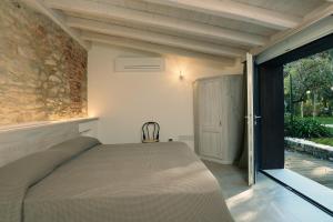 a bedroom with a bed and a sliding glass door at Al segnavento Tramontana in Toscolano Maderno +32 photos