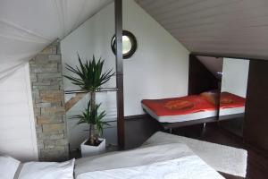 a bedroom with a bed and a mirror at Ferienhaus zum Frankenblick in Sonneberg +20 photos