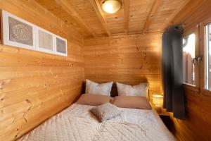 a bedroom with a bed in a wooden room at Haus Seebrise - Marina Mücheln in Mücheln