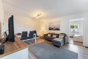 a living room with a couch and a tv at Insel Koje 1 in Fehmarn