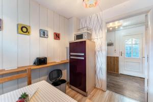 a kitchen with a refrigerator and a table at Insel Koje 1 in Fehmarn