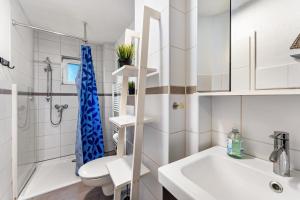 a bathroom with a toilet and a shower and a sink at Insel Koje 1 in Fehmarn +18 photos