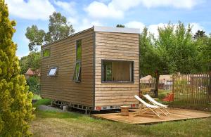 a tiny house sitting on a wooden deck at La tiny house de la Blandinière in Vertou +6 photos