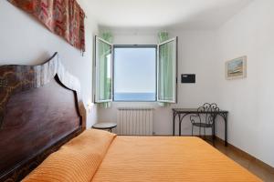 a bedroom with a large bed and a window at Agriturismo La Realidad in Finale Ligure +119 photos