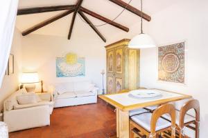 a living room with a table and a couch at Casa Mucchi Bianchi PC33 in Arzachena