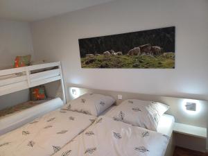 a bedroom with a bed and a picture on the wall at Ferienwohnung Panoramablick in Bad Wildbad