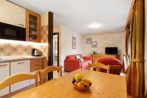 a kitchen with a table with a bowl of fruit on it at I Mini Appartamenti in Livigno