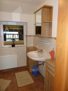 a bathroom with a sink and a window at Ferienhaus Lemberger in Jochberg +33 photos