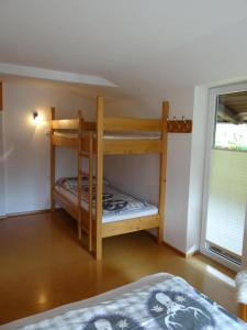 a bedroom with two bunk beds in a room at Ferienhaus Lemberger in Jochberg