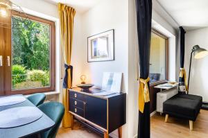 a bedroom with a desk and a chair and a window at Schwabenseenestle in Uhldingen-Mühlhofen