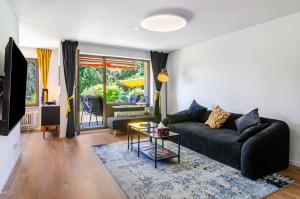 a living room with a couch and a table at Schwabenseenestle in Uhldingen-Mühlhofen