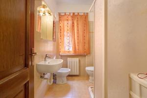 a bathroom with a sink and a toilet at Casa D'Agostino in Aosta +24 photos