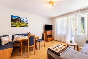 a living room with a couch and a table at Lorenz in Triberg