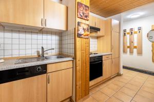a kitchen with wooden cabinets and a sink at Lorenz in Triberg