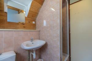 a bathroom with a sink and a toilet and a mirror at Chalet les moraines 8 in Le Tholy +18 photos