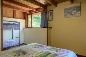a bedroom with a bunk bed and a window at Chalet les moraines 8 in Le Tholy