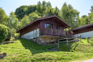 a house with a porch and a balcony at Chalet les moraines 8 in Le Tholy