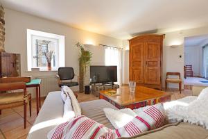 a living room with a couch and a table at Typical House Completely Renovated in Saint-Alban-dʼAy