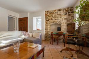 a living room with a couch and a table at Typical House Completely Renovated in Saint-Alban-dʼAy