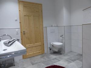 a bathroom with a toilet and a sink at Fischerhof in Höchenschwand +28 photos