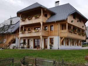 a large wooden house with a gambrel at Fischerhof in Höchenschwand