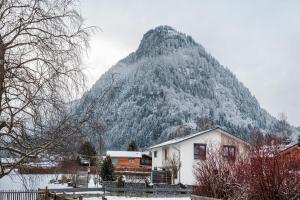 a house in front of a snow covered mountain at Haus Bergliebe in Pfronten