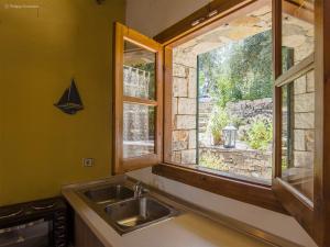 a kitchen with a sink and a window at Adamantia Studio S3 in Gaios