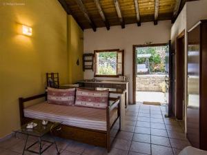 a room with two beds and a kitchen with a table at Adamantia Studio S3 in Gaios +2 photos