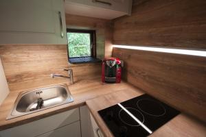 a small kitchen with a sink and a stove at Blockhaus Quellental in Odderade