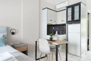 a small kitchen with a table and a bed at Sunset Premium Studio 7 in Lefkada