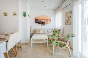 a living room with a couch and chairs at Almdna15-atc in Torrevieja