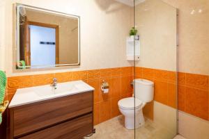 a bathroom with a toilet and a sink and a mirror at Almdna15-atc in Torrevieja +17 photos