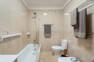 a bathroom with a toilet and a bath tub at Maresía in Los Abrigos +19 photos