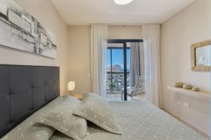 a bedroom with a large bed with a large window at Maresía in Los Abrigos