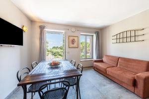 a living room with a table and a couch at Abaye 5 Barolo - Charm Adults Only in Soiano del Lago
