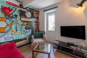 a living room with a wall covered in stickers at La maison d'à côté in Carpentras