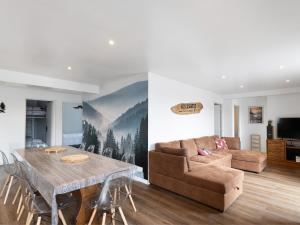 a living room with a couch and a table at Residence les Isards in Formiguères