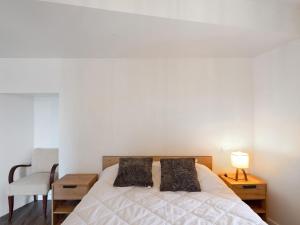 a bedroom with a bed and a table and a chair at Residence les Isards in Formiguères