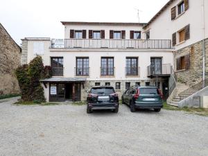 two cars parked in front of a building at Residence les Isards in Formiguères