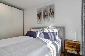 a bedroom with a bed with striped pillows at Purer Genuss - Exklusive in Owingen