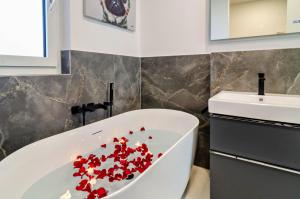 a bathroom with a white tub filled with red confetti at Purer Genuss - Exklusive in Owingen +27 photos
