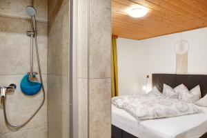 a bedroom with a shower and a bed at Ferienwohnung Piburgersee in Oetz +74 photos