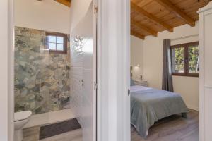 a bathroom with a shower and a bed in a room at Los Barranquillos in Las Palmas de Gran Canaria +20 photos