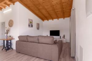 a living room with a couch and a tv at Los Barranquillos in Las Palmas de Gran Canaria