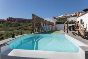 a swimming pool in the backyard of a villa at Los Barranquillos in Las Palmas de Gran Canaria