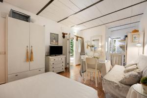 a bedroom with a bed and a living room at La Posada de la Pinaleta in Chiclana de la Frontera