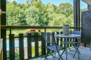 a table and chairs on a balcony with a view at L’ourson in Les Déserts