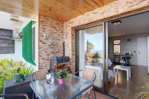 a room with a table and chairs and a living room at Sunset Apartment in Puerto Rico de Gran Canaria