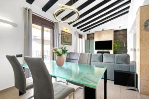 a dining room with a glass table and a couch at Somni in Jávea